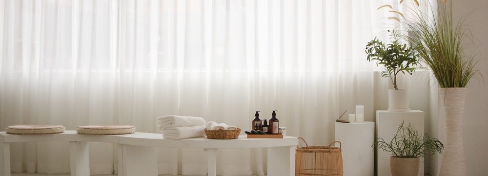 Spa-style bathing corner with towels and plants